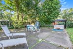 Backyard patio with outdoor furniture, BBQ grill, and hot tub
